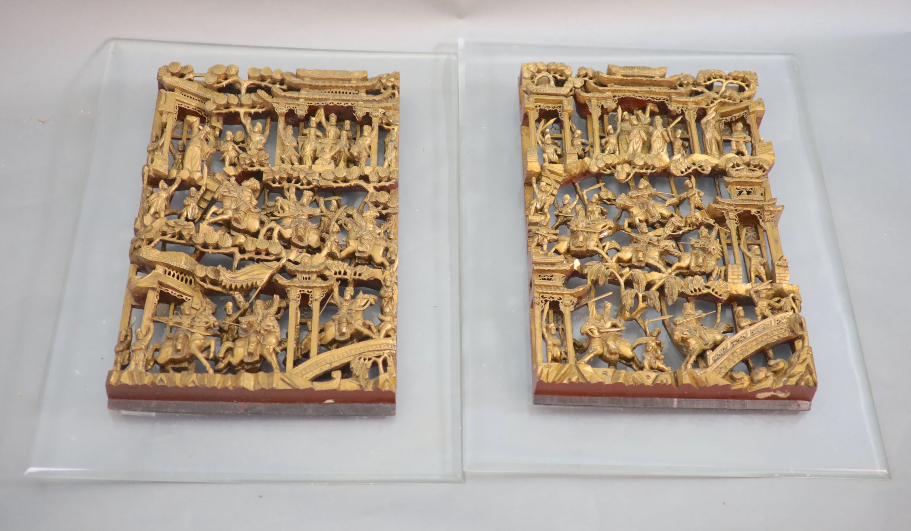 A pair of Chinese giltwood panels, late 19th century 63.5 x 40.5cm excluding Perspex mount
